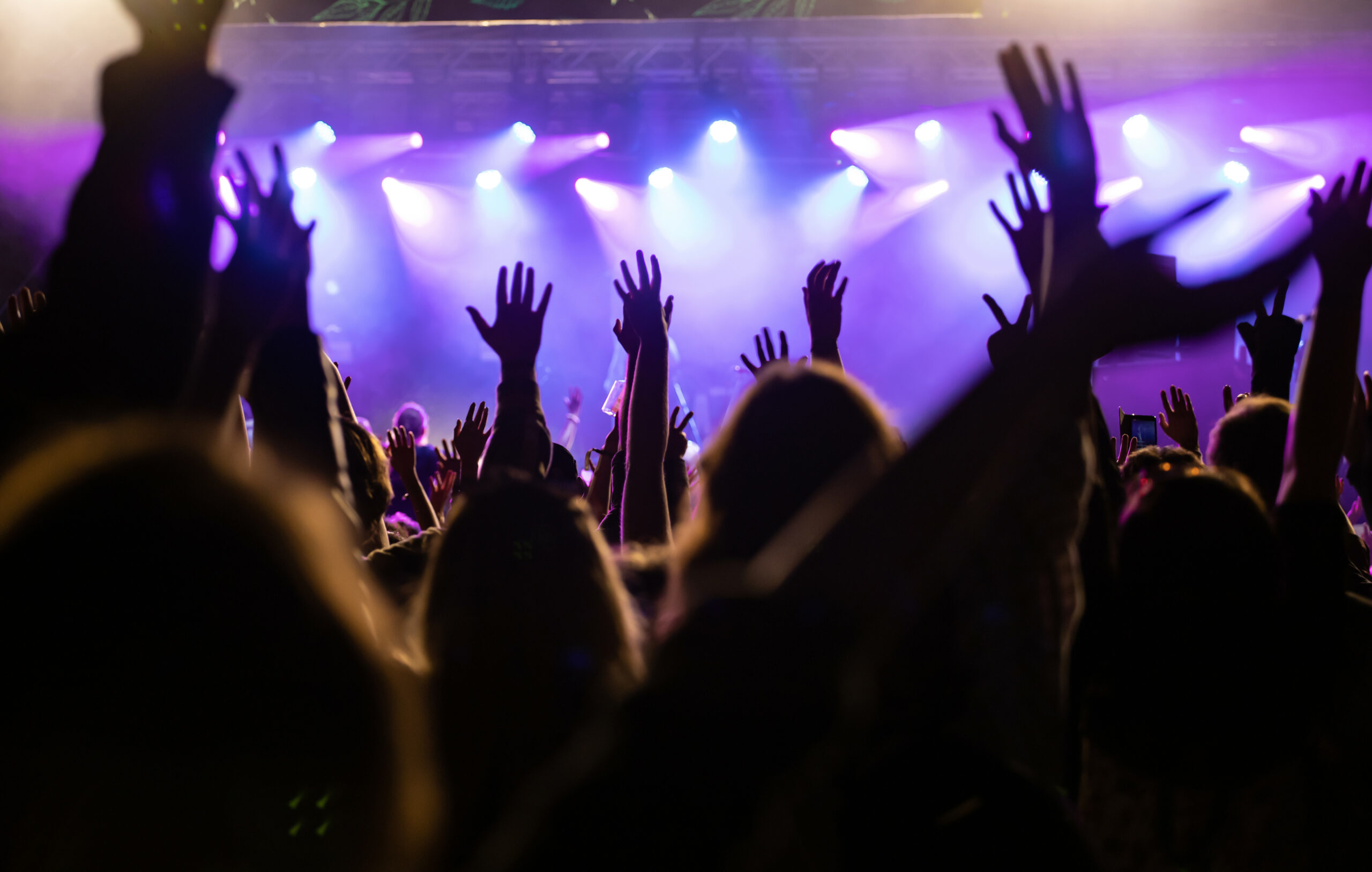 Crowd at concert and blurred stage lights. Crowd at concert - Cheering crowd in front of bright colorful stage lights